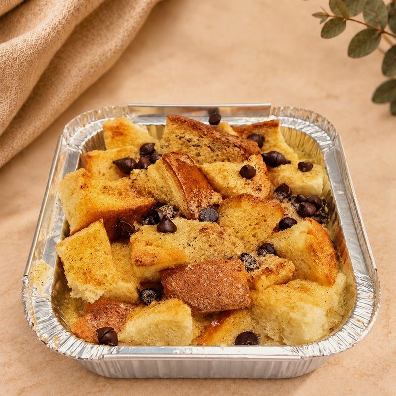 Single portion of brioche bread and butter pudding with homemade custard sauce