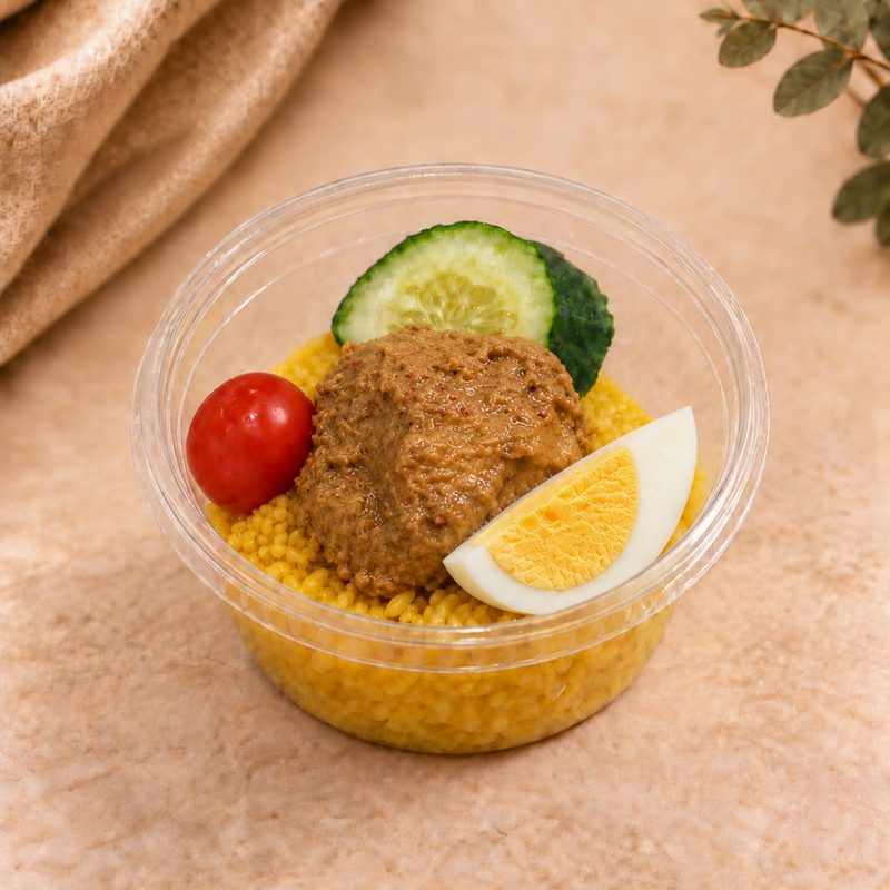 Pulut Kuning berkat cup with chicken rendang, cucumber, tomato and boiled egg