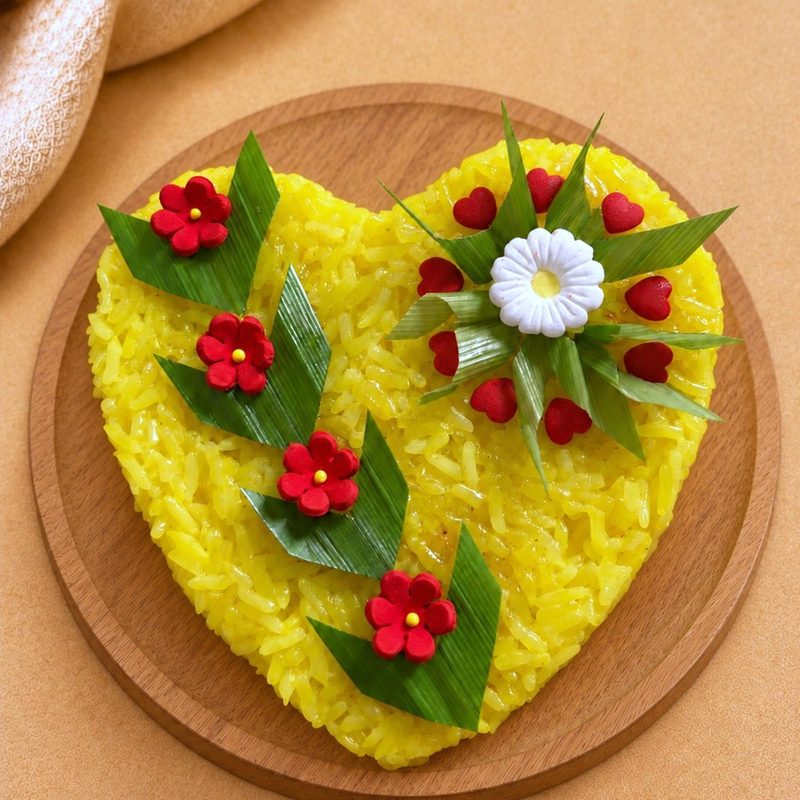 Pulut Kuning celebration cake decorated with cherry tomatoes, quail eggs and greens