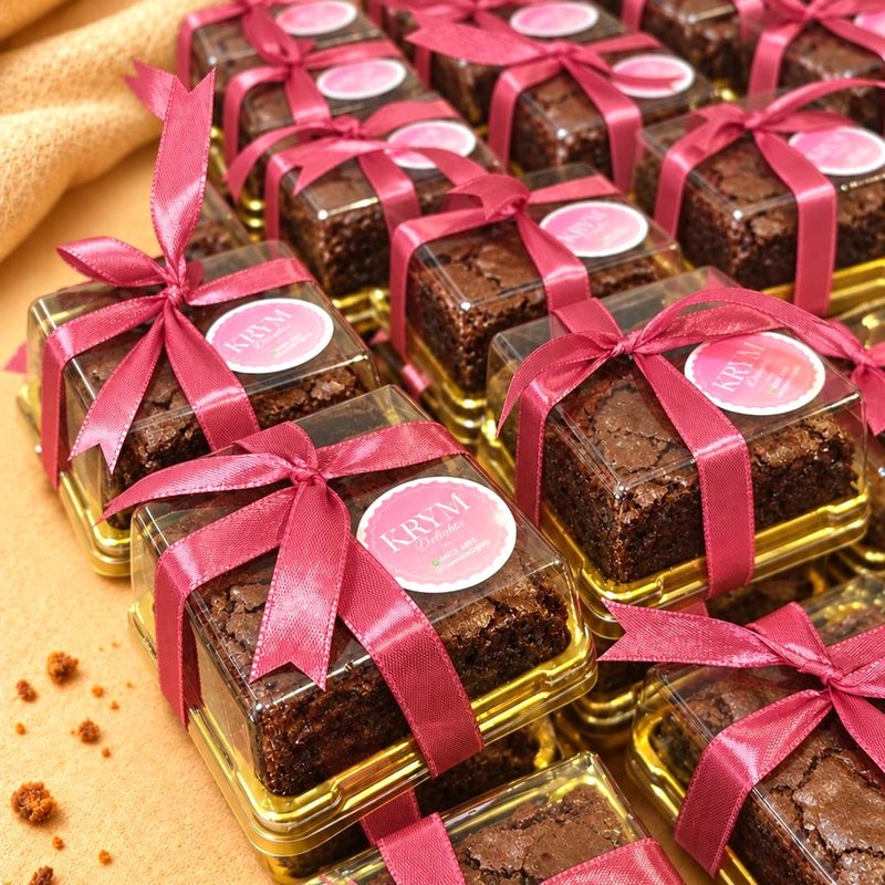 Rows of sea salt brownie party favour boxes tied with pink ribbon and a KRYM Delights sticker