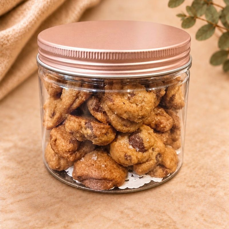 Jar of sea salt chocolate chip cookies with flaky salt and a rose gold lid, 180g
